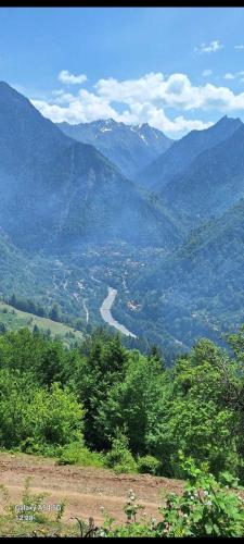 a view of a valley with a river and mountains at Lela Guest House in Mestia