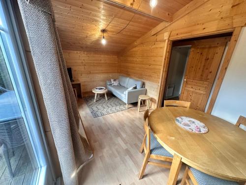 une salle à manger avec une table et un canapé dans l'établissement Chalet 45m2, à Mios