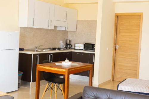 a small kitchen with a table and a refrigerator at Beauty Plaza Apartaments in Santa Maria