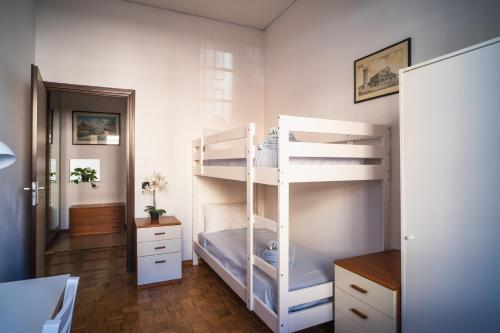 a bedroom with a white bunk bed with a ladder at Residence Molinetto in Ravenna