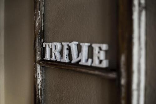 a wooden door with the word true written on it at Trillevallens Högfjällshotell & Lägenheter in Trillevallen