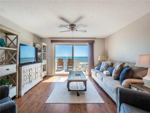 a living room with a couch and a table at Ocean Dunes 2112 in Kure Beach
