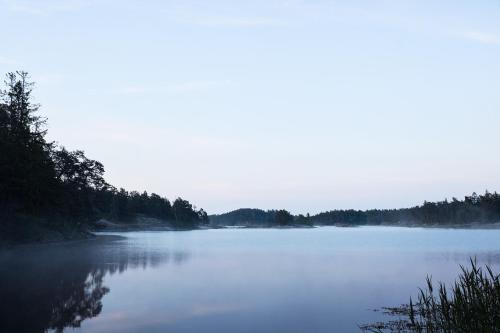 a view of a large body of water with trees at Landet, Designer Cabins in the Swedish Archipelago in Västerljung