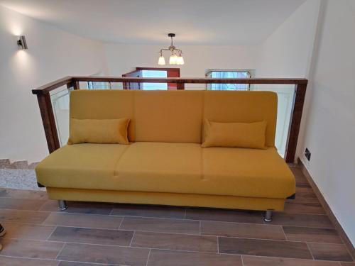 a yellow couch sitting in a living room at Piazza Varese in Valentano