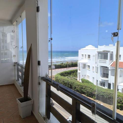 a balcony with a view of the ocean at Ocean Vista Escape in Dar Bouazza