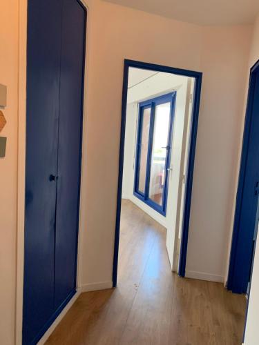 an empty room with a door and a window at Paris La Défense - Santorin Apartment with jacuzzi in Courbevoie
