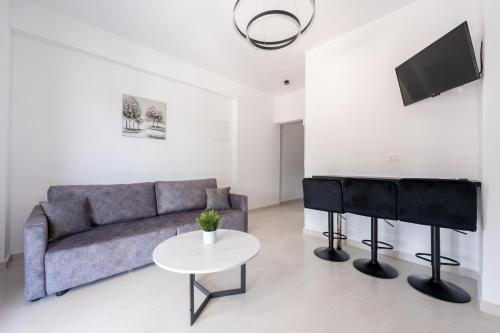 a living room with a couch and a piano at Central Square View Flogita in Flogita