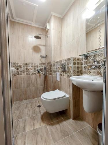 a bathroom with a toilet and a sink at CASA DEL SOL Sozopol in Sozopol