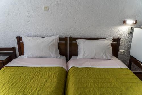 two beds sitting next to each other in a room at Hotel Malia Holidays in Malia