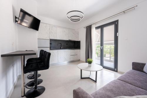 a living room with a couch and a table at Central Square View Flogita in Flogita