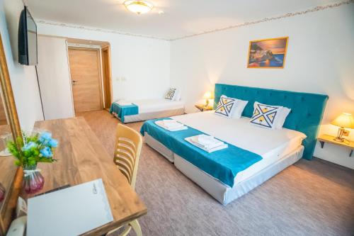 a hotel room with a bed and a table and a tableablish at Royal Calisto Hotel in Sozopol