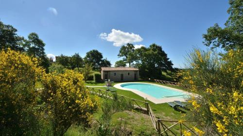 a villa with a swimming pool and a house at Noce in Roccalbegna