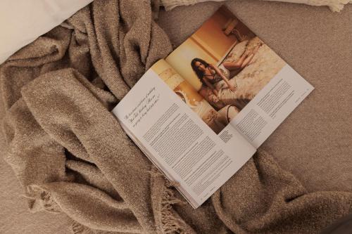 a book laying on top of a blanket at Due Venti Downtown Suites Naxos Junior in Naxos Chora