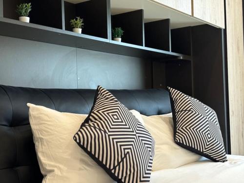 a bed with two pillows on top of it at San Anton Gardens 3BDR Apartment in Balzan