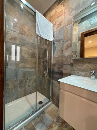 a bathroom with a shower and a sink at San Anton Gardens 3BDR Apartment in Balzan