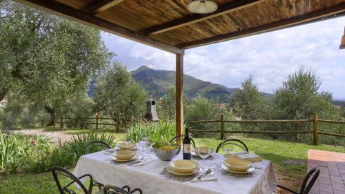 a table with a white table cloth and chairs on a patio at Fico in Calci