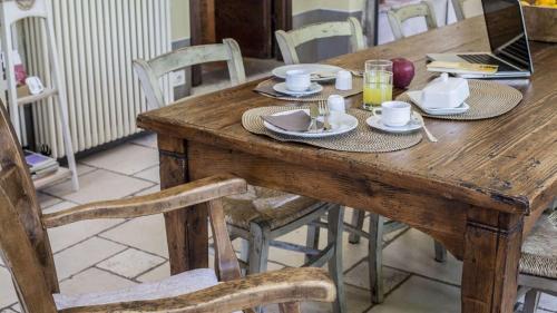 a wooden table with plates of food and drinks on it at Villa Il Colto in Terranuova Bracciolini