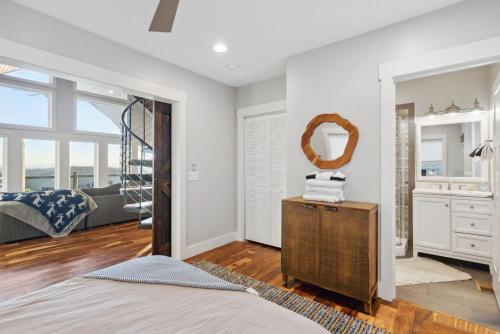 a bedroom with a bed and a mirror at 2 Cabins & Views for Miles Hot Tubs Pool Table in Swiss