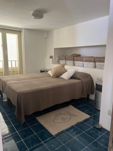 a bedroom with a large bed in a room at Agenzia Isotur ATTICO SUL PORTO in Ponza