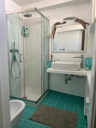 a bathroom with a sink and a shower at Agenzia Isotur ATTICO SUL PORTO in Ponza