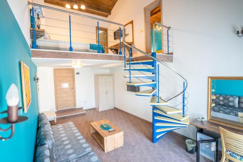 a spiral staircase in a living room with a couch at Royal Calisto Hotel in Sozopol