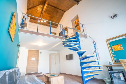 a spiral staircase in a room with a living room at Royal Calisto Hotel in Sozopol