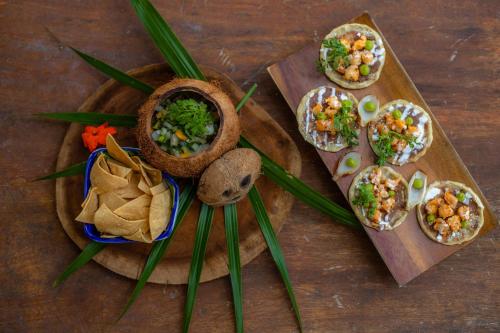 a wooden tray with different types of food on it at BT Live Tulum located at the party zone in Tulum