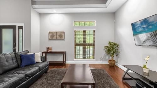 a living room with a couch and a table at Book Your Summer Escape - TownHome by Disney! in Orlando