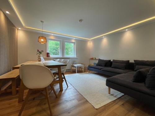 a living room with a couch and a table at Harz Escape in Torfhaus