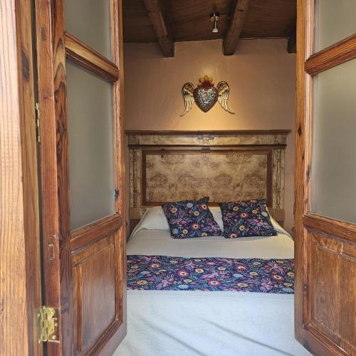 a bedroom with a bed in a room with an octopus on the wall at HOTEL CASA BAEZ in Pátzcuaro
