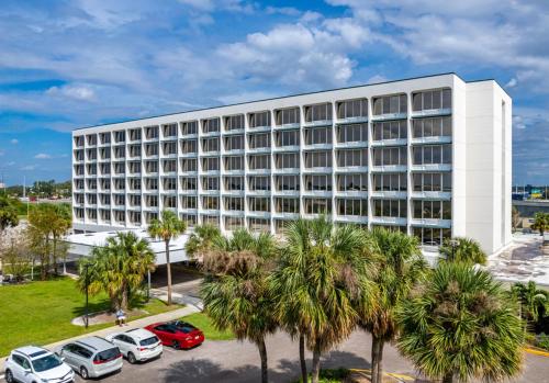 a large white building with cars parked in a parking lot at The View Studio, Suites and Event Venue in Orlando