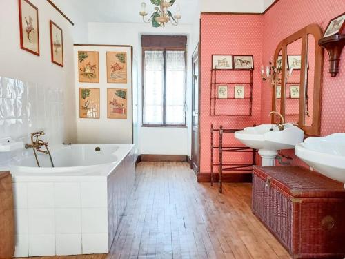 La salle de bains est pourvue de 2 lavabos, d'une baignoire et de 2 lavabos. dans l'établissement Le Haras des Charmilles, à Varaville