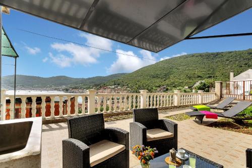 a patio with chairs and a table on a balcony at Casa Del Porto - Vis in Vis