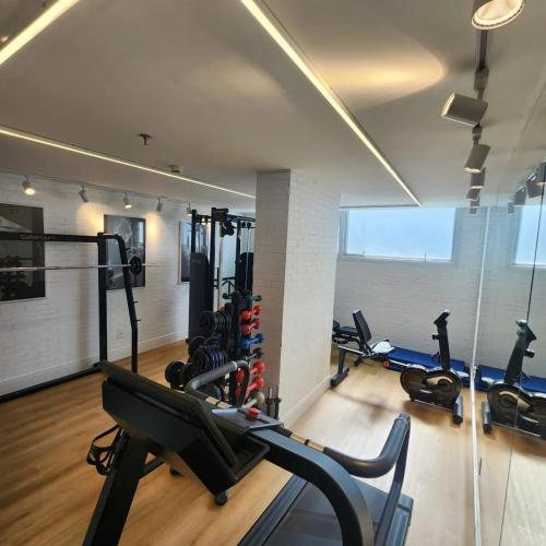a gym with treadmills and ellipticals in a room at Linhares Design Hotel in Linhares