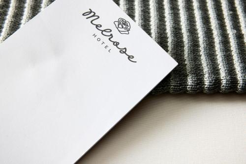 a piece of paper sitting on top of a blanket at The Melrose Hotel in Bronx