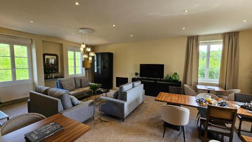 a living room with a couch and a table at Maison d'hôtes Café Bulle in Jonquery