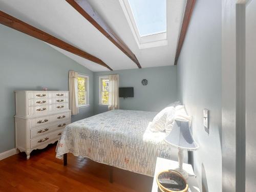 a bedroom with a bed and a dresser and a window at 10 Chadwell Avenue Sandwich - Cape Cod in Sandwich