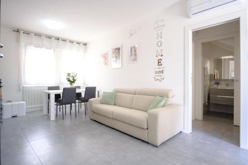a living room with a couch and a table at RESIDENCE LA TORRE appartamento FLOWER free parking in Padova