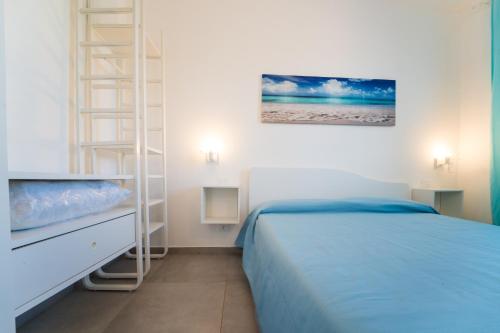 a bedroom with a bed and a ladder in it at Villa Gioiello CENTRO in Favignana