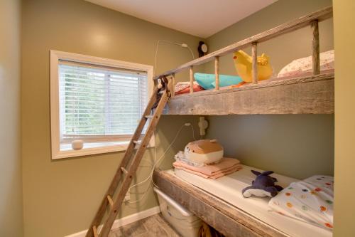 a room with two bunk beds and a window at Cozy Goode Cabin with Deck about 17 Mi to Lynchburg in Goode