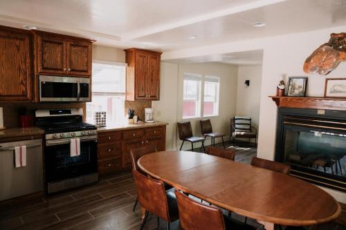 a kitchen with a wooden table and a dining room at The Long Barn Lodge in Long Barn