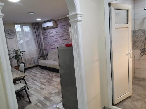 a living room with a couch and a table at Dream Land Batumi in Batumi