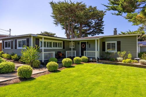 a house with a lawn in front of it at Coastal Charm Inviting 3 BR Montara Home in Montara