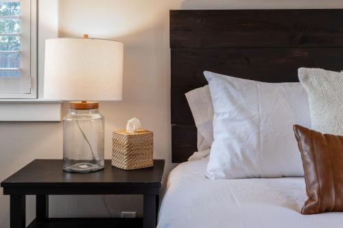 a bedroom with a bed and a table with a lamp at Coastal Charm Inviting 3 BR Montara Home in Montara