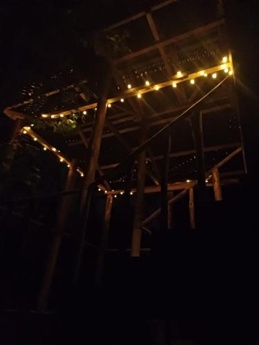 a string of lights on a pergola at night at Paraiso Verde in Chijoú