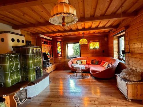 a living room with a couch and a table at Großzügiges Landhaus im Grünen in Oberpiesting