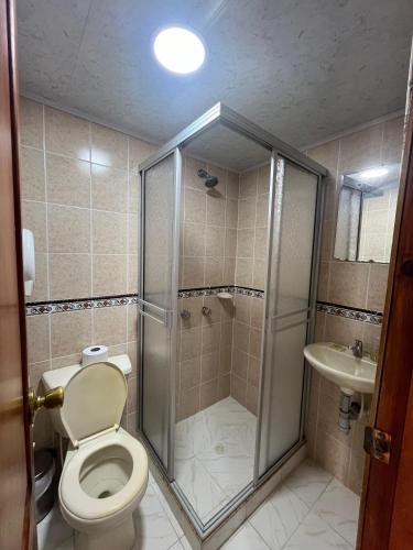 a bathroom with a shower with a toilet and a sink at Casa hotel villadiana in Armenia