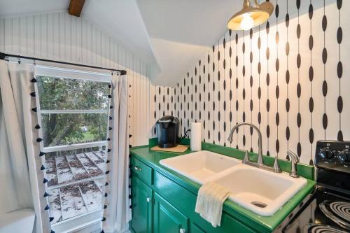 a kitchen with a green sink and a window at Stonewall Bungalow 4 - Sleeps 3 in Stonewall