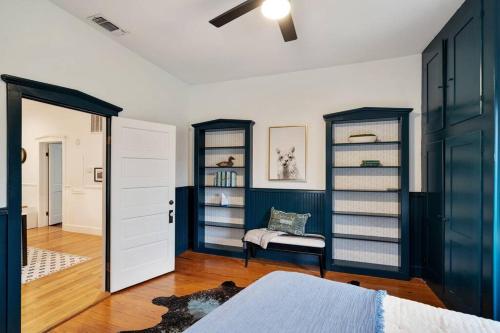 a bedroom with blue and white walls and a door at Stonewall Main Haus - Sleeps 6 in Stonewall