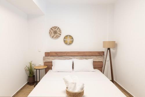 a bedroom with a bed and a clock on the wall at Kalimera Apartments in Litochoro